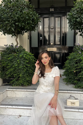 a lady wears a white tulle midi dress with a matching top